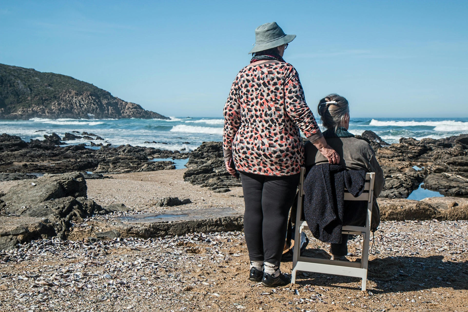 Elderly woman with companion having tea
