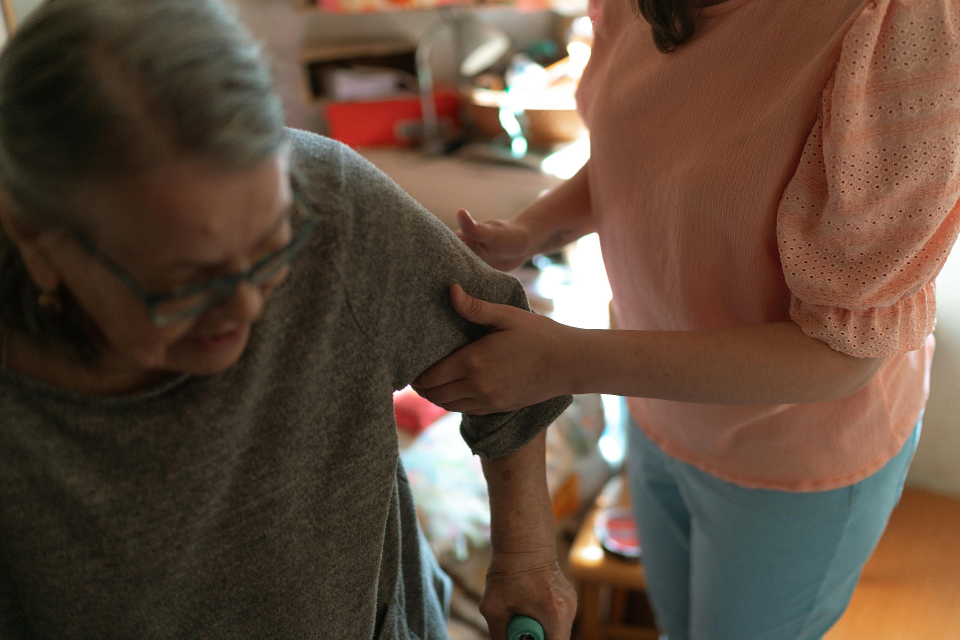 Care worker and client preparing food together